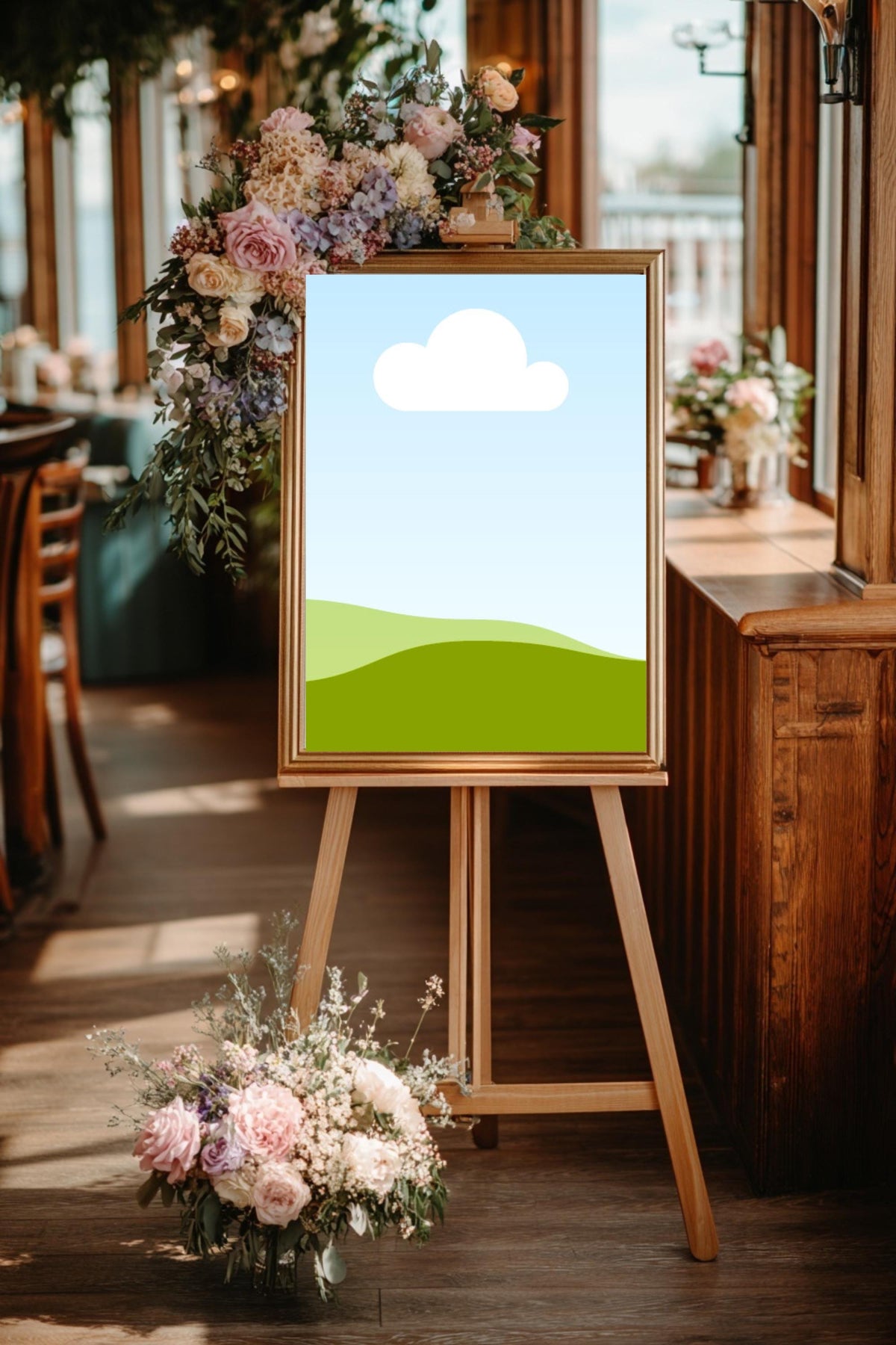 Garden wedding place card on wooden easel with cloud-and-hills design