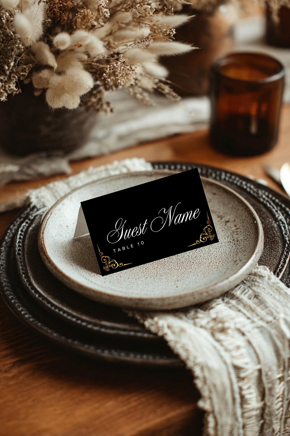 Place card mockup on round plate with black cover and gold script name