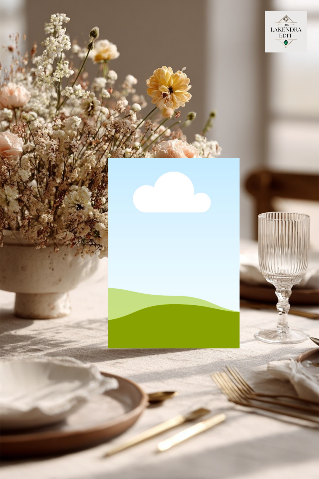 Wedding invitation card mockup standing on easel with blue sky, cloud, and green hills design